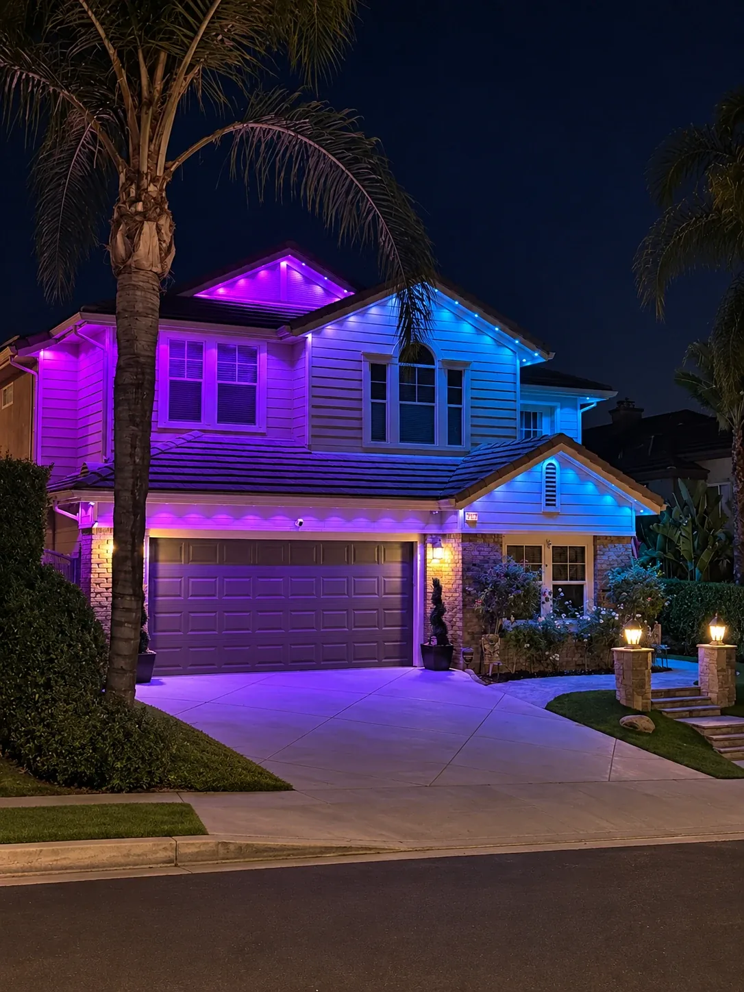 Two-story home with purple and blue Aurix permanent roofline lighting