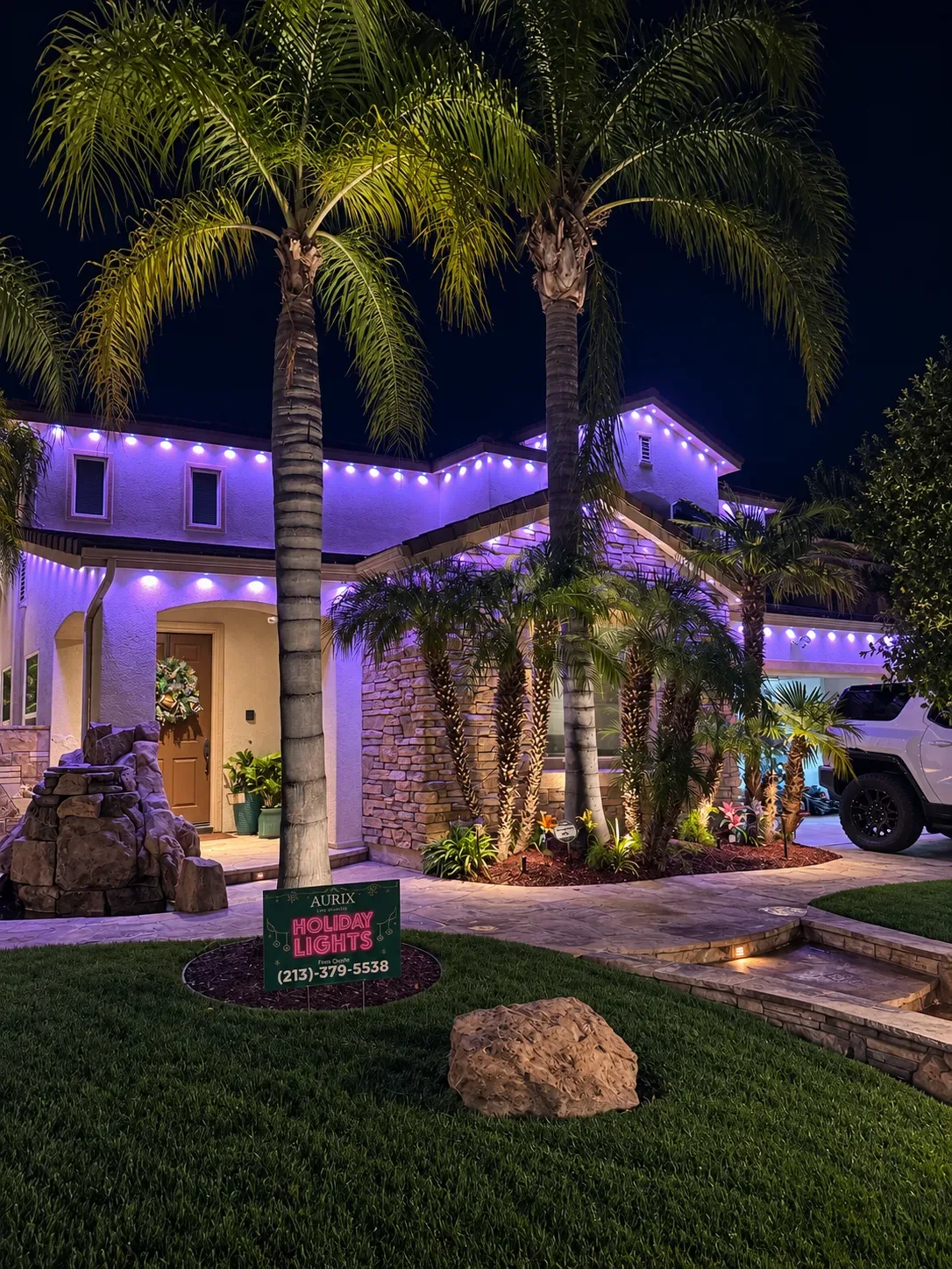 Aurix permanent lighting install in purple with an Aurix yard sign out front